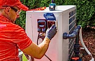Outdoor Swimming Pool Heat Pump Maintenance Performed by Professional Pools Specialist. Caucasian Male in His 40s.